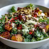 Tender massaged kale forms the base of a nutritious Kale Salad Bowl topped with crunchy almonds and pumpkin seeds.