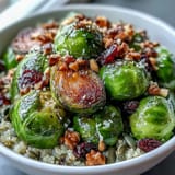 Roasted Brussels Sprouts Bowl topped with crunchy pecans, chewy cranberries, and tangy balsamic drizzle, ready to eat.