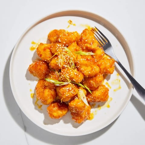Crispy battered chicken bites tossed in a glossy, sweet and tangy orange sauce.