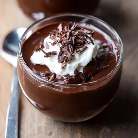 Rich chocolate pudding with fresh berries, offering a vibrant contrast to the dark dessert