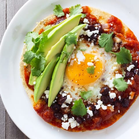 Fresh avocado slices and crumbled cheese garnish this easy vegetarian breakfast.