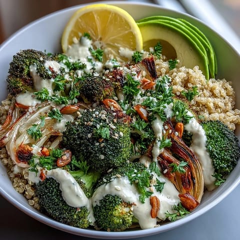 Crispy baked broccoli florets and onions on warm grains, garnished with sesame seeds, parsley, and a bright lemon wedge.