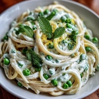 Creamy Lemon Ricotta Pasta with bright peas and fresh mint.